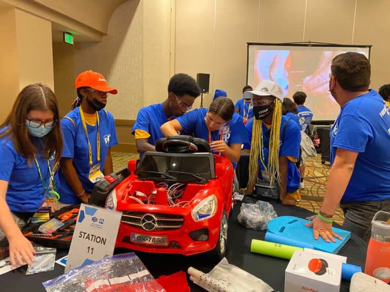 Local Boys & Girls Club youth help build physical therapy cars for toddlers with mobility challenges