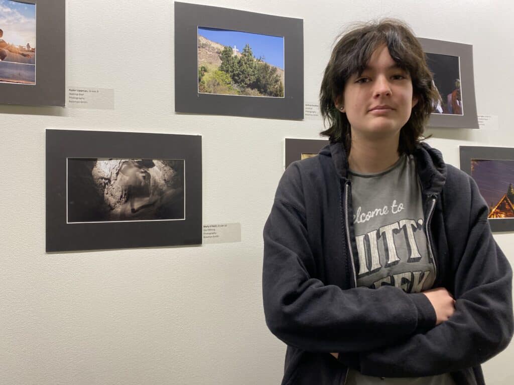 Malibu High sophmore Molly ONeil poses with her photo Soul Mining at the 2023 Student Art Exhibit reception on Feb 26
