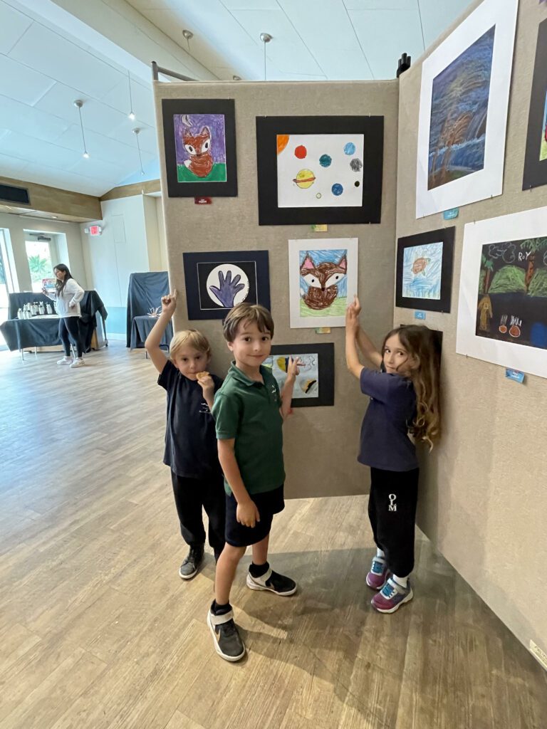 First graders Leo Liev and Sienna show off their works