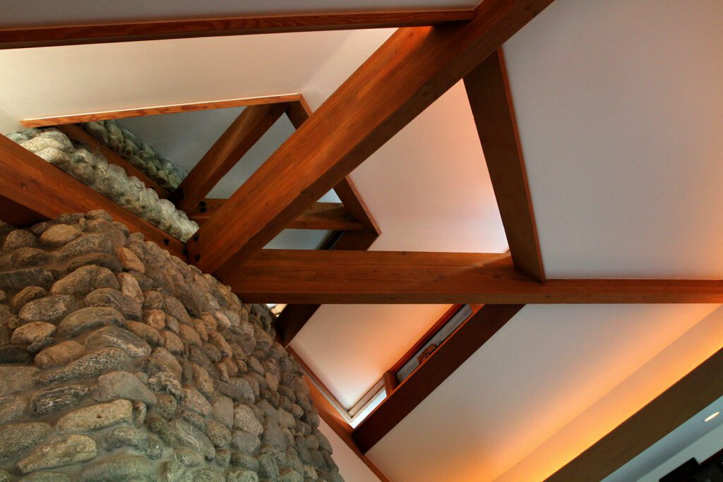 Detail of fireplace and layered beams in the MAHMA Great Room. Photo by Juan Tallo