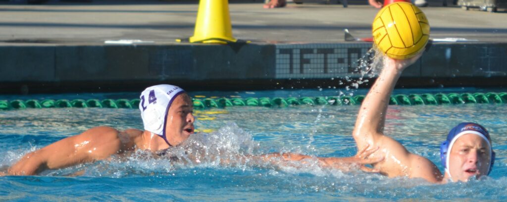 A Waves mens water polo player looks to pass the ball against Cal Lutheran. Photo by McKenzie Jackson. 1 1