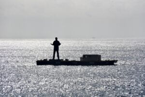 Giant statue floating on a barge off the coast of Malibu on Sunday as seen from the hillside. Photo by Bobby LaBonge