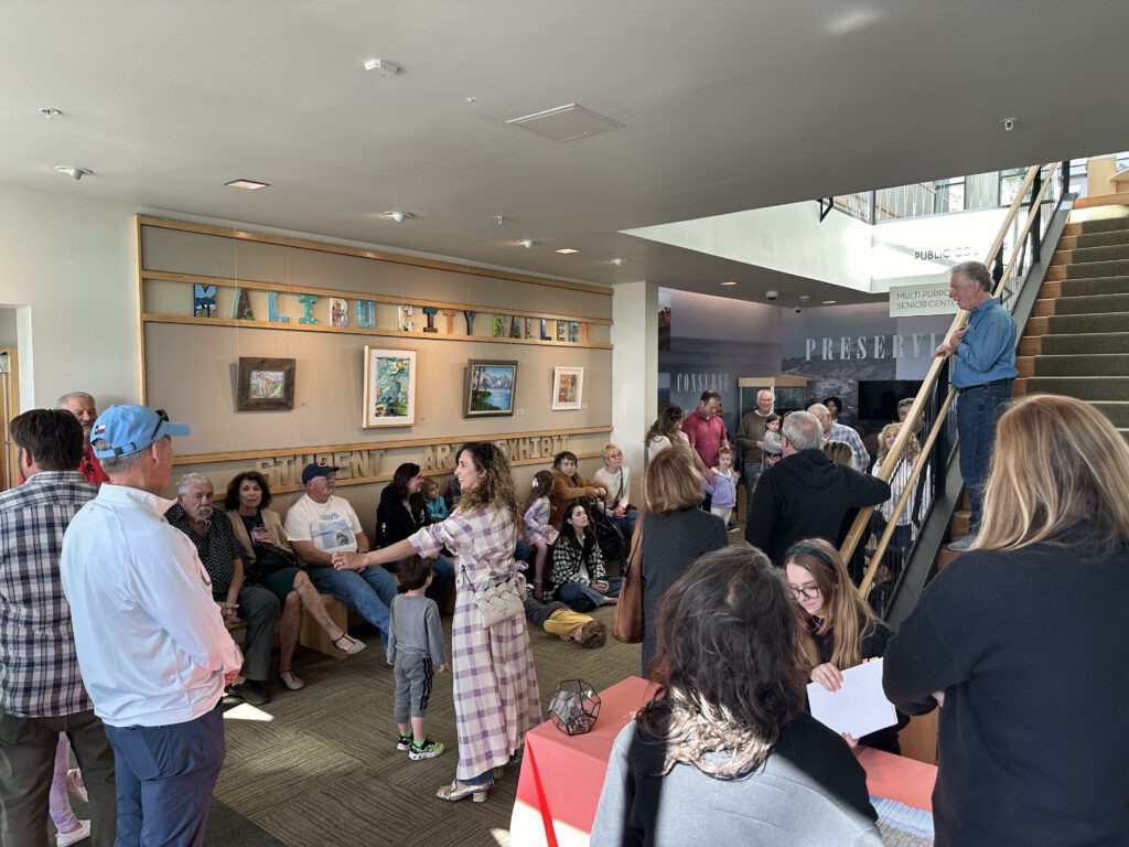 Malibu Arts Commission Chairman Fireball Lawrence addresses the families of artists at the Student Art Exhibit closing reception at City Hall