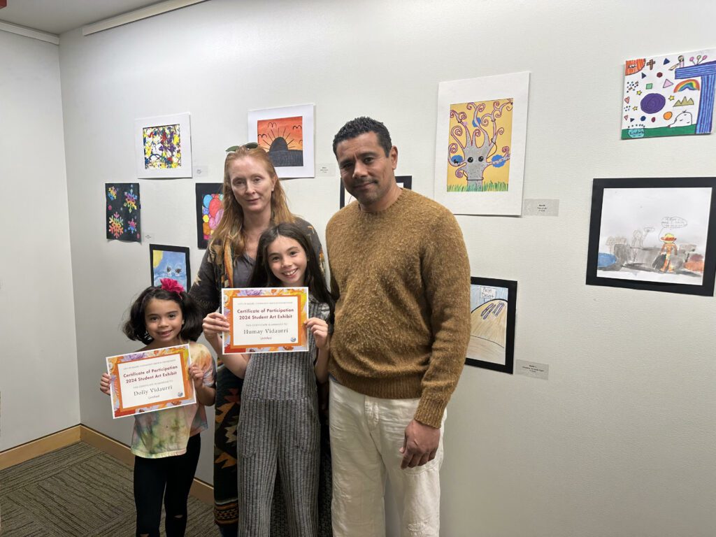 The Viduarri sisters pose with family during the Student Art Exhibit closing reception