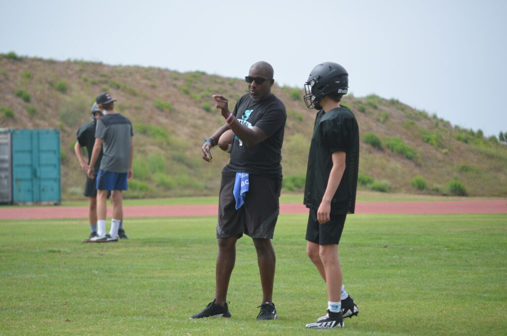 Malibu Sharks assistant coach Jerrel Hamilton coaches a Malibu defensive player during the 2023 preseason. Hamilton is starting a youth flag football league in Malibu. Photo by McKenzie Jackson