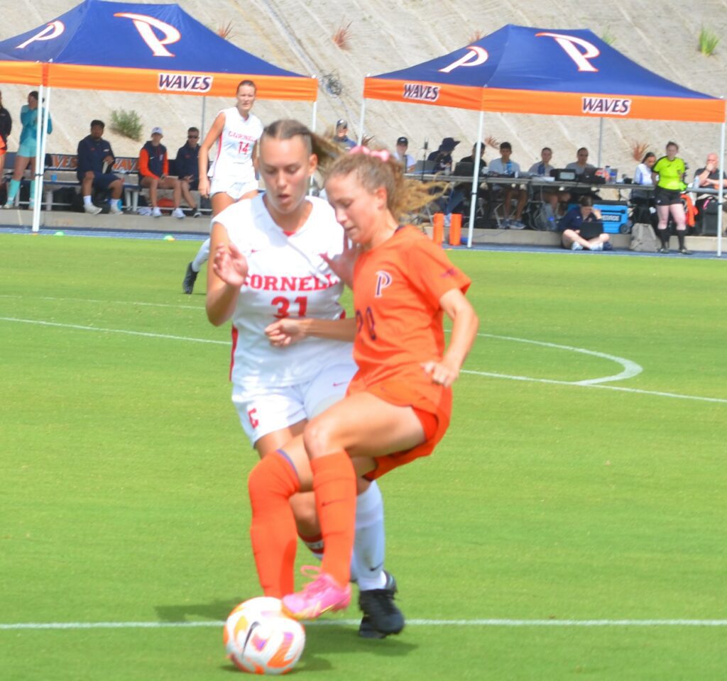 Pepperdine Tori Waldeck a graduate student handled the ball against a defender. Photo by McKenzie Jackson